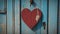 red wooden door A blank wood sign with a red heart on a blue door. The sign is old and worn, and the heart is cozy