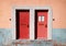 Red wooden doors on the facade of an old house in Tagus Port Belem Lisbon