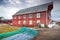 Red wooden fishing barn with drying nets