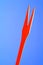 Red Wooden Fork on Blue Background