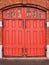 Red wooden gates of vintage fire station.