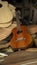 Red wooden guitar on a pile of unassembled guitar parts