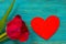 Red wooden heart and wine color tulip on turquoise rustic planks