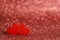 Red wooden hearts on a shiny surface