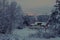 Red wooden house in winter landscape