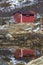 Red wooden hut on the shoreline of Stonnesbotn Fjord