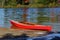 Red wooden kayak on a lake