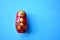Red wooden matryoshka doll on the blue background