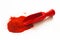 Red wooden scoop with paprika on white background