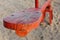 Red wooden seesaw playground