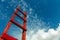 Red wooden staircase against the blue sky. Development Motivation Business Career Heaven Growth Concept