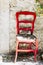 Red wooden style bistro chair in the street