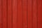 Red wooden texture background. Bloody, beautiful old painted wooden wall or fence close up. Solid colour backdrop for design