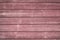 A red wooden wall with a lot of texture from an hold small house. For any kind of background, wallpapers and desingns.