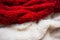 Red wool texture and white texture close up, cotton wool, red and white fabric, beige fluffy fur