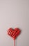 Red woven heart on a earthy background.