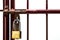 Red wrought iron window frame. The yellow key is locked. Isolate white background