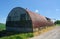 Red WW2 Nissen hut. Agricultural storage.  UK