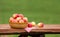 Red and Yellow Apples in the Basket on the rough Wooden Table