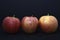 Red and yellow apples on a black background. Delicious apples close-up