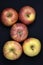 Red and yellow apples on a black background. Delicious apples close-up