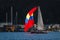 Red, yellow, blue spinaker sailboat