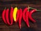 Red and yellow chilis on dark rustic background