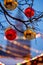 Red and yellow Christmas balls on branch. On the background in the defocus of the with Christmas lights with view on Spasskaya