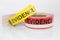 Red and yellow evidence tape on white background