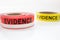 Red and yellow evidence tape on white background