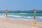 Red and yellow flags on patrolled beach indicating safe to swim area