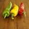 Red, yellow and green Italian long peppers. Conceptual image