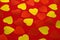 Red and yellow hearts on red textiles. Valentine background