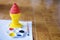 Red and yellow ice cream cone plaster and painting plate with brush on the ground