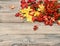 Red and yellow leaves on wooden texture. Autumn retro