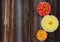 Red, yellow and orange dahlias on old wooden background