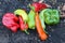 Red, yellow, orange and green capsicums on a garden bed