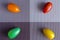 Red, yellow, orange and green oval tomato on a rectangular background