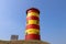 The red and yellow Pilsum lighthouse on the East Frisian North Sea coast