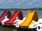 red and yellow plastic water slides on small lake on a bright summer day