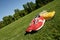 Red and yellow running shoes on a sports field