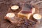 Red and yellow soaps with a scented candle in a romantic setting. Spa concept on wooden background. Wellness concept
