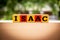 Red and yellow wooded blocks that spell the name Isaac