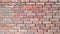 Reddish brickwork with wide cement grouting