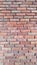 Reddish brickwork with wide cement grouting