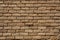 Reddish brown rectangular clay brick wall of an old house