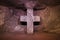 Reddish illuminated stone cross in famous underground salt cathedral of Zipaquira, Colombia