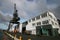 Redevelopment of seashore with refurbished gray historic crane and renovated storehouse on Queens Wharf, Wellington, New Zealand