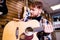 redhair ginger man is choosing quality acoustic guitar in guitar shop