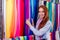 Redhair ginger woman choosing color textile in tailor shop for new cloth sewing.she determines the colors that best suit